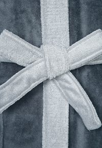 Gray bathrobe made of soft terry material with a matching belt tied in a knot. Features a plush texture and a wide, flat band at the center.