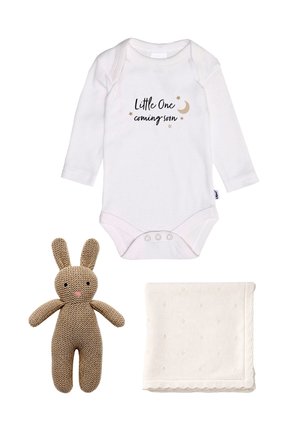 White long-sleeve baby onesie with "Little One coming soon" text, knitted brown bunny toy, and folded cream baby blanket with small patterns.