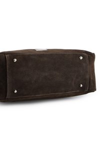 Brown suede handbag base, rectangular shape, featuring four metal feet. Smooth texture with subtle stitching and a small logo patch on top.