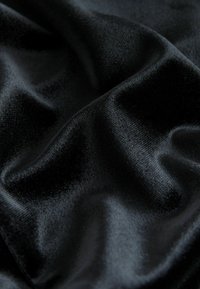Black satin fabric with a smooth, glossy texture, displaying soft folds and delicate sheen across the surface.