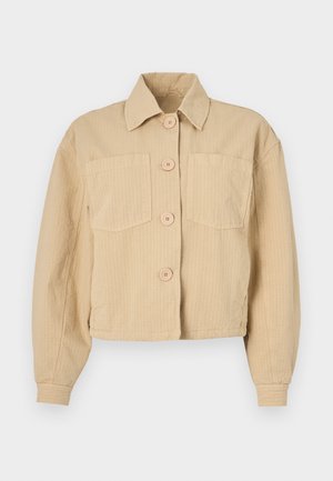 Giacca cropped beige realizzata in tessuto a coste, con colletto a punta, maniche lunghe e due tasche frontali con bottoni rotondi.