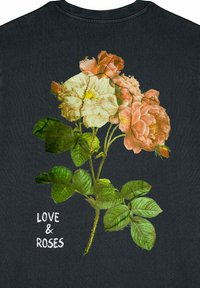 Black t-shirt featuring a floral print with white and pink roses and green leaves. Text reads "LOVE & ROSES" in white.