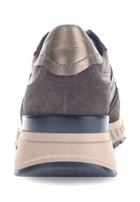 Brown suede sneaker featuring a metallic leather heel cap, a cushioned beige sole, and black rubber accents on the tread.