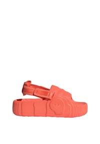 Coral-colored sandals with a textured rubber upper, adjustable strap, and contoured sole featuring ridges and a logo detail.