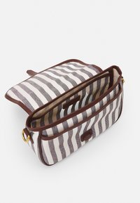 Bolsa de tela a rayas con ribete de cuero marrón. Cuenta con una abertura superior y compartimentos interiores. Rayas horizontales en gris y blanco roto.