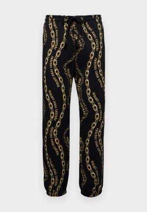 Black sweatpants featuring a gold chain pattern, intertwined with text, and an elastic waistband with drawstring for adjustable fit.