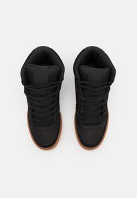 High-top sneakers with a black textile upper, black laces, and a brown rubber sole. Features padded collar and logo detail on the tongue.