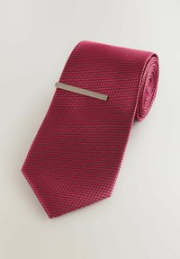 Red tie with a textured pattern, showcasing a woven design. Features a metal tie clip for secure fastening.