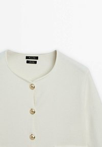 Ivory wool cardigan with a round neckline, featuring five gold-tone buttons down the front and a small pocket on the left side.