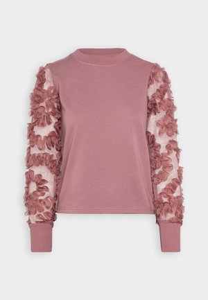 Top w kolorze mauve z długim rękawem, z gładkim górnym stanem i przezroczystymi rękawami ozdobionymi teksturowanymi kwiatowymi aplikacjami i ściągaczami.