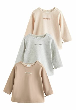 Three long-sleeve baby tops in beige, gray, and tan, each with small text: "HAPPY DAYS," "LITTLE & LOVED," and "BIG SMILES."
