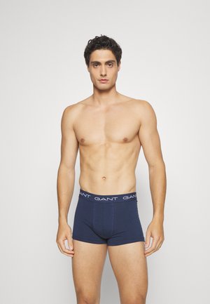 Navyblaue Baumwoll-Boxershorts mit einem weißen, gebrandeten Bund, die ein enges Design und eine glatte Textur aufweisen.