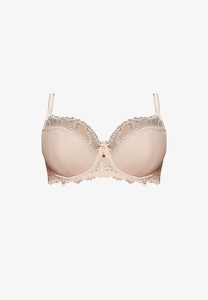 Beige csipke melltartó, merevítővel, sima kosarakkal és díszes csipke szegéllyel. Állítható pántokkal és középen masni akcentussal rendelkezik.