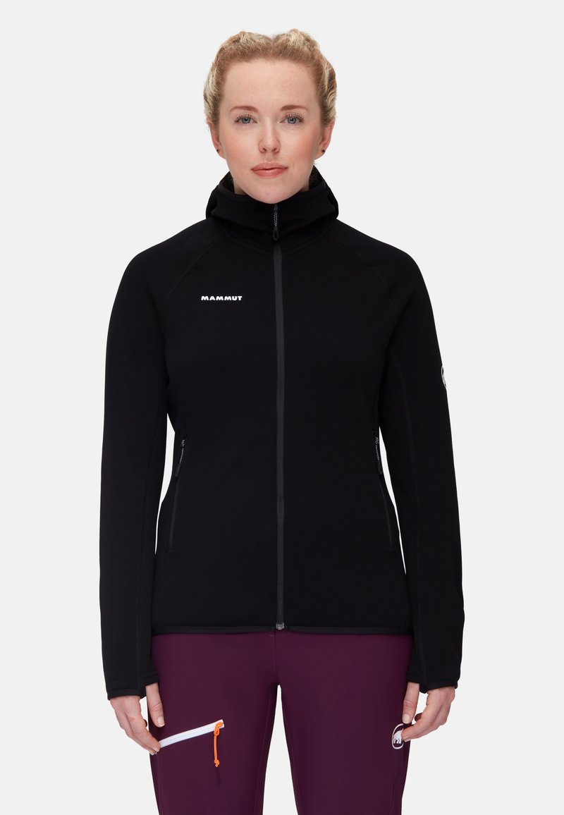 Black fleece jacket with high collar, zip closure, and logo on the chest. Features two zippered side pockets and a smooth texture.