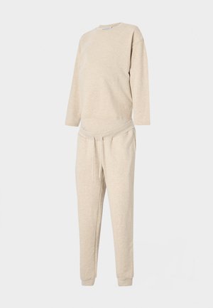 Beige sweatshirt and pants set made from soft material, featuring a round neckline, long sleeves, and a drawstring waist. Regular fit.