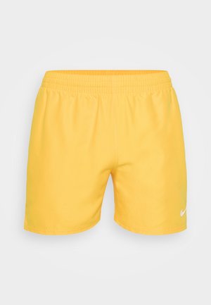 Shorts amarillos de Nike con cintura elástica, textura suave y acento de logo blanco en la parte inferior derecha.