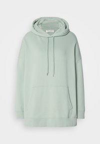 Sweat à capuche oversize vert clair avec poche devant, capuche à cordon et longues manches, présenté sur un fond blanc uni.