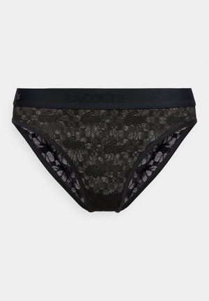 Culottes en dentelle noire avec un motif floral et crocodile, dotées d'une ceinture unie noire embossée du nom de la marque Lacoste.