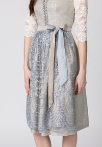 Light blue and silver lace dress with a satin light gray ribbon. Features intricate embroidery and a fitted bodice with decorative buttons.