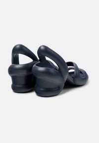 Navy blue sandals with a molded design, featuring wide straps and a chunky, sculpted heel for added support and comfort.