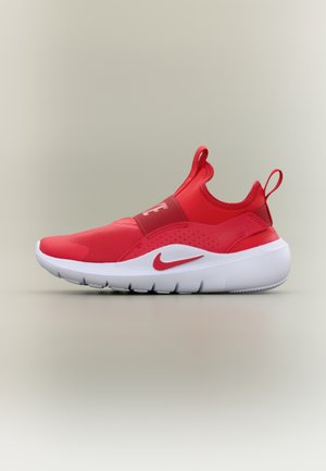 Piros, könnyen felhúzható sportcipő fehér talppal, Nike pipa logóval az oldalon, rugalmas pánttal a lábközépen, valamint húzópántokkal a nyelvnél és a saroknál.
