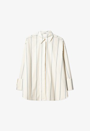 Visiškai kreminė marškinė su vertikaliomis mėlynomis juostelėmis, su smailiu apykaklė, ilgomis rankovėmis ir vieno mygtuko rankogaliais. Pagaminta iš medvilnės.