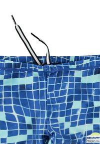 Sinised ujumispüksid ruudustikuga, millel on must-valged paelad, elastne vöökoht ja kerge kangas.