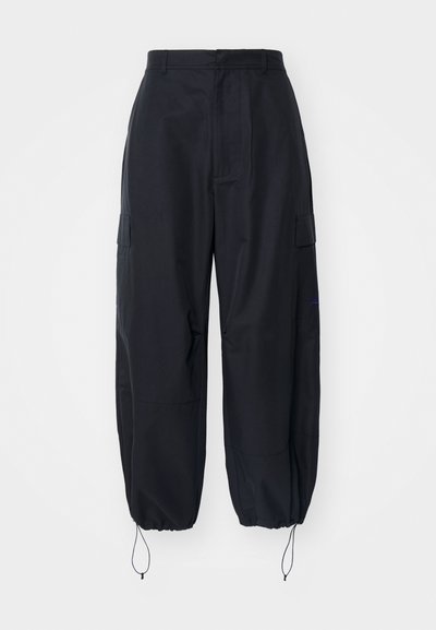 Black cargo pants with adjustable cuffs, two side pockets, and a subtle logo accent. Made from lightweight, smooth fabric.