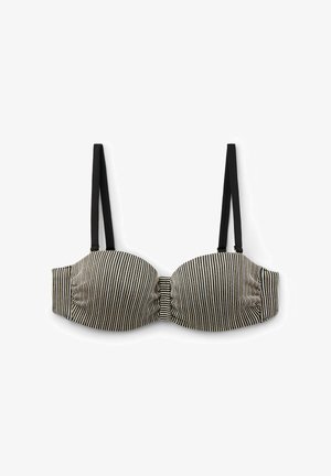 Soutien-gorge rembourré à rayures noires et blanches avec bretelles noires ajustables, présentant un détail plissé au centre et une texture lisse.