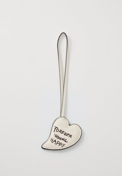 Heart-shaped white leather keychain with black outline and text "FOREVER YOUNG HAPPY" in bold lettering. Features a loop for attachment.