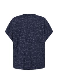 Blouse bleu marine à manches courtes avec des pois blancs, coupe ample et ourlet droit, vue de dos sur un fond blanc.