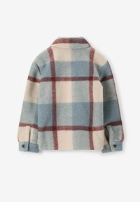 Veste en polaire à carreaux dans des tons crème, bleu et rouge. Dotée d'un col, de manches longues et de poignets à boutons. Texture douce avec une coupe décontractée.