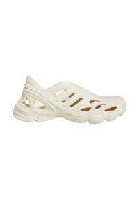 Cream-colored molded shoe featuring open cutouts, a rounded toe, textured surface, and a thick, contoured sole for comfort.