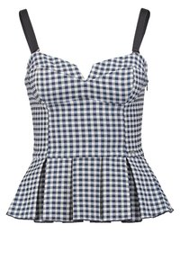 Top peplum in pied de poule blu navy e bianco, dotato di spalline nere regolabili, scollatura a V e orlo svasato in vita.