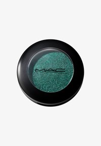 MAC eyeshadow in a round black case features a green, shimmery texture visible through a clear lid. The shade has a fine, sparkly finish.