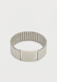 Μεταλλικό βραχιόλι με ευέλικτη μπάντα, με ματ ασημί φινίρισμα. Χαραγμένο "HUGO" σε ορθογώνιο κούμπωμα. Κομψός και μοντέρνος σχεδιασμός.