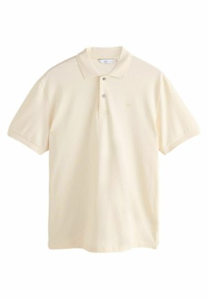 Polo shirt in crème kleur van zacht materiaal. Beschikt over een twee-knopensluiting, korte mouwen en een subtiele geborduurde logo op de borst.