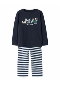 Tumesinise pikkade varrukatega pidžaama ülemine osa, millel on "LASTE MAGADA" graafika ja koomiksite loomad, koos tumesiniste ja valgete triibuliste pükstega. Pehme kangastekstuuri.