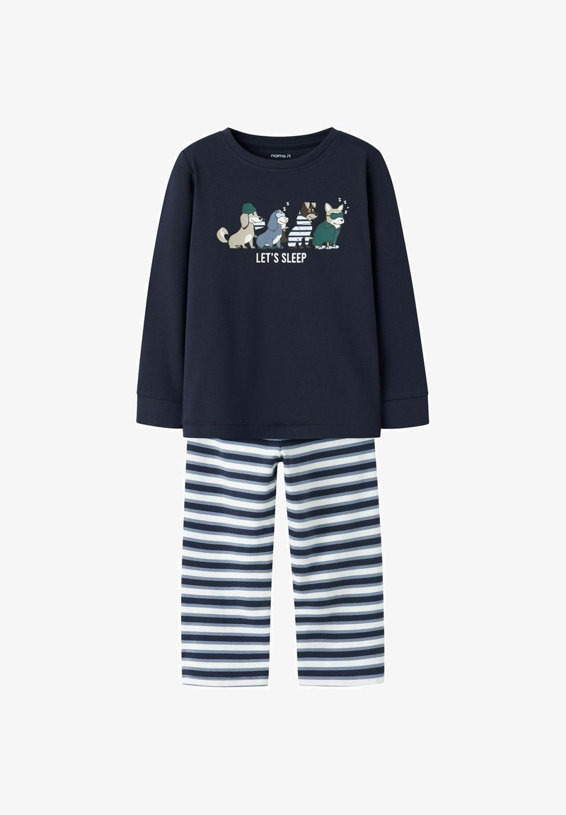 Tumesinise pikkade varrukatega pidžaama ülemine osa, millel on "LASTE MAGADA" graafika ja koomiksite loomad, koos tumesiniste ja valgete triibuliste pükstega. Pehme kangastekstuuri.