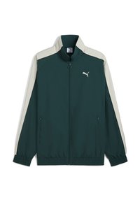 Puma jack met rits in donkergroen met crèmekleurige zijpanelen, elastische manchetten en zoom. Bevat een logo op de borst en ritszakken aan de zijkant. Lichtgewicht materiaal.