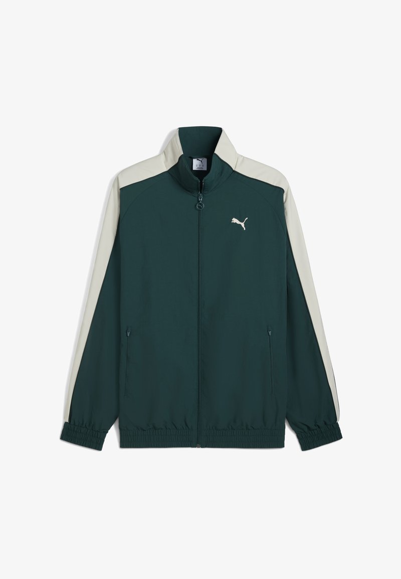 Puma jack met rits in donkergroen met crèmekleurige zijpanelen, elastische manchetten en zoom. Bevat een logo op de borst en ritszakken aan de zijkant. Lichtgewicht materiaal.