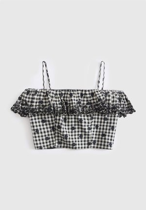 Zwart-wit geruit crop top met dunne bandjes, off-shoulder ruches en zwarte bloemenborduursel langs de rand van de ruches.