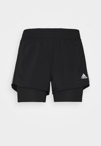 Černé sportovní šortky s vnější vrstvou volného střihu a vnitřní těsně přiléhající vrstvou. Obsahují tři bílé pruhy a logo Adidas.