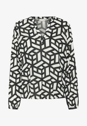 Blouse à manches longues présentant un motif géométrique en cubes noir et blanc, avec un décolleté en V et des manches à poignet. Fabriquée en tissu léger.