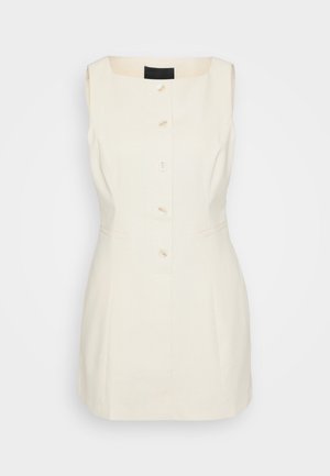 Sukienka bez rękawów w kolorze kremowym z kwadratowym dekoltem, pięcioma guzikami z przodu i kieszeniami po bokach. Wykonana z usztywnionego materiału.