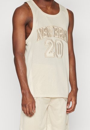 Beige mesh basketball jersey with "NEW ERA" and "20" in gold lettering. Features a classic tank design with a round neckline and breathable texture.