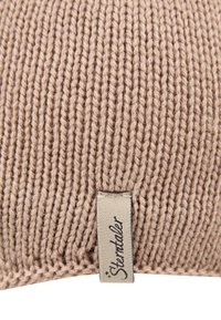 Knitted cushion in soft beige fabric with prominent ribbed texture. Features a small, sewn label with the brand name "Sterntaler."