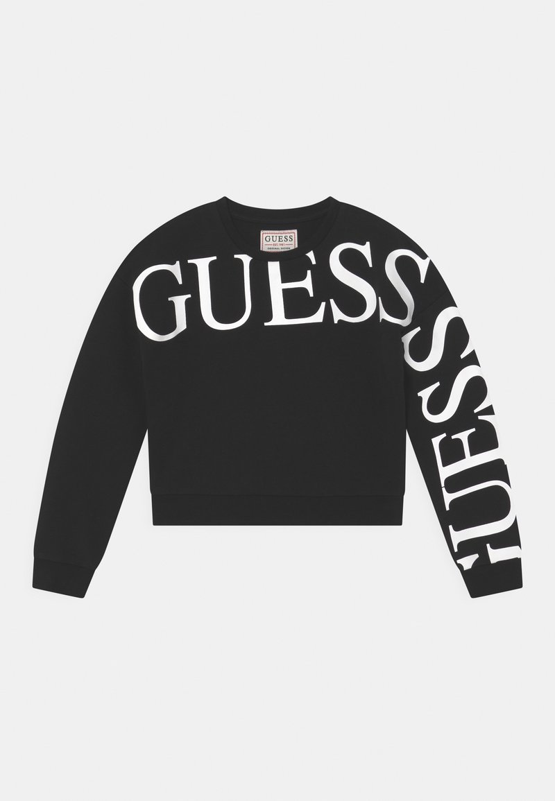 Sweat-shirt noir court avec grands logos "GUESS" blancs sur le devant et la manche. Tissu doux avec encolure ronde et poignets côtelés.