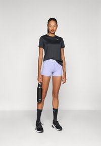 Black athletic t-shirt, purple patterned shorts, black sneakers, and dark socks. Holding a black water bottle. Simple, minimalistic design.