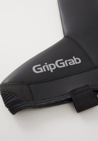 Černé neoprenové vodní boty s texturovanou šedou gumovou podrážkou. Na boku se nachází stříbrné logo "GripGrab". Hladký povrch, aerodynamický design.